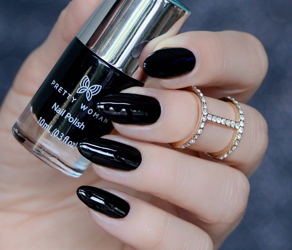 Close-up of a hand wearing Nobody Cares Black Nail Polish - Pretty Woman NYC